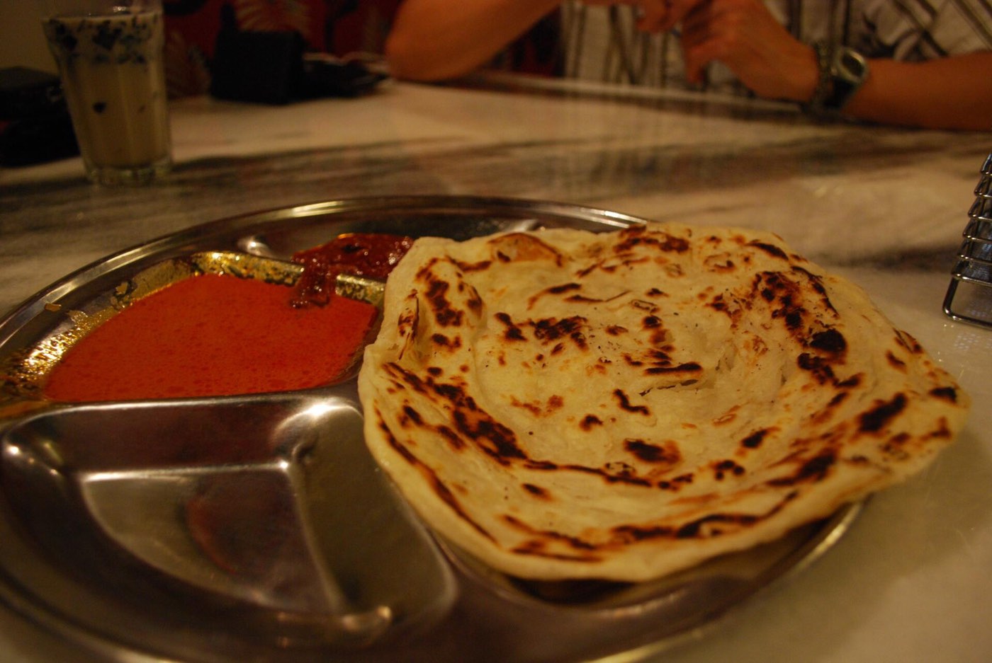 Roti canai being cooked at a mamak stall